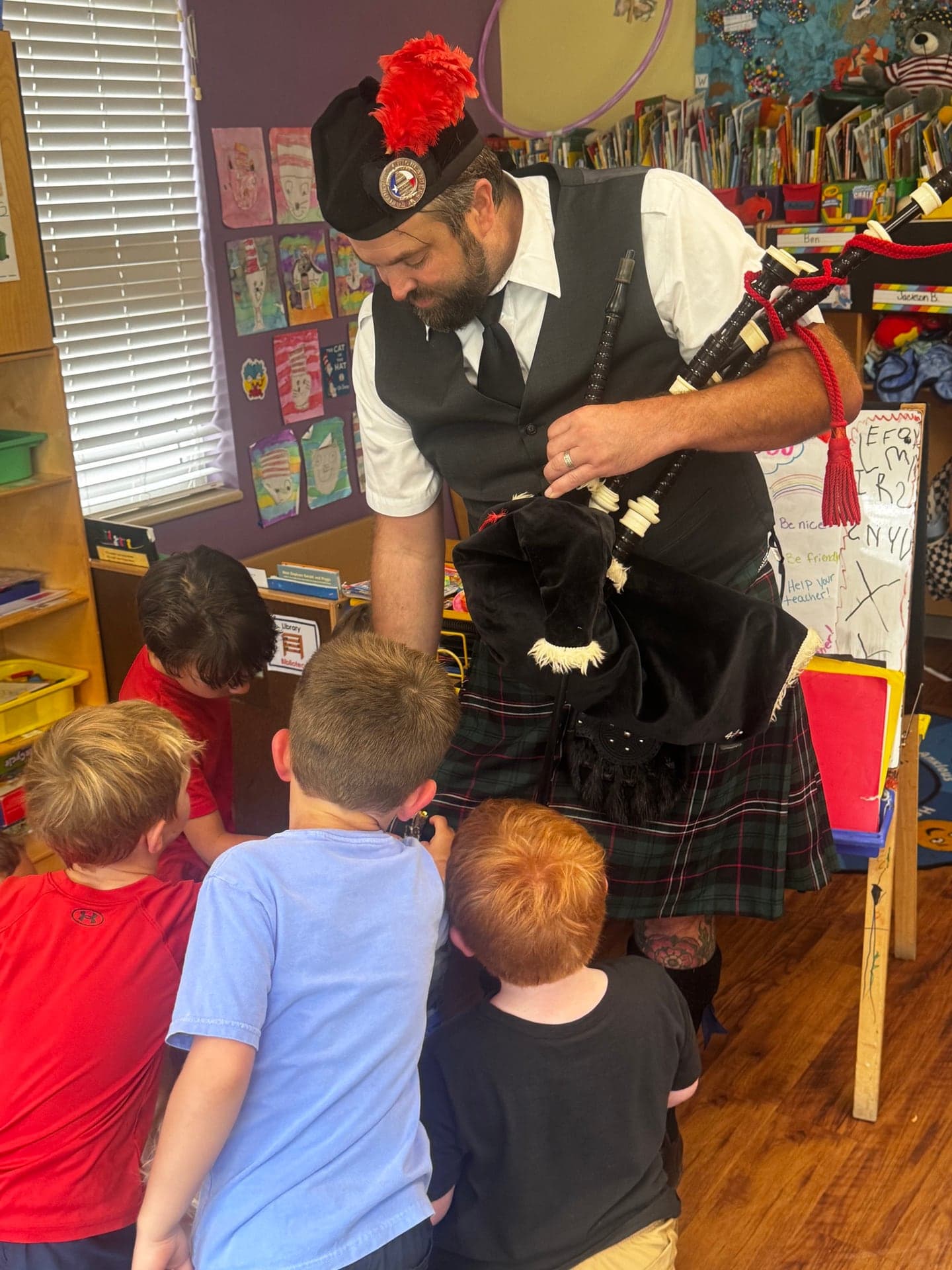 Ryan Guthrie showing students the parts of the Highland bagpipes during a classroom visit